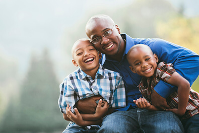 Man smiling with sons